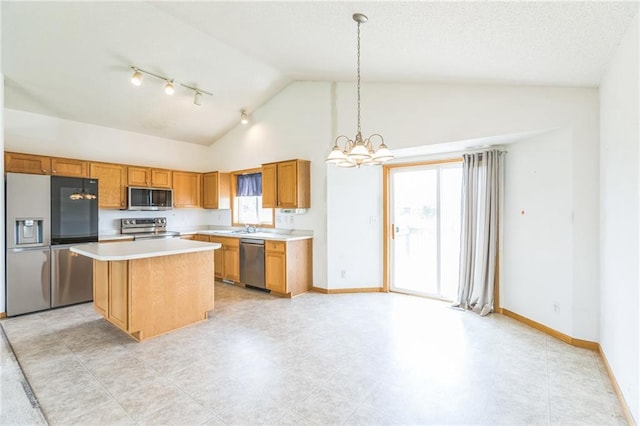 1566 Mallard Ave, Baldwin, WI 54002 - kitchen featuring appliances with stainless steel finishes, a chandelier, a center island, light countertops, and brown cabinetry