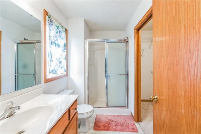 1566 Mallard Ave, Baldwin, WI 54002 - full bath featuring a shower stall, vanity, a textured ceiling, and a spacious closet
