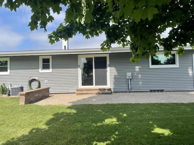 1508 Hoover St, New Holstein, WI 53061 - back of house with a lawn and a patio