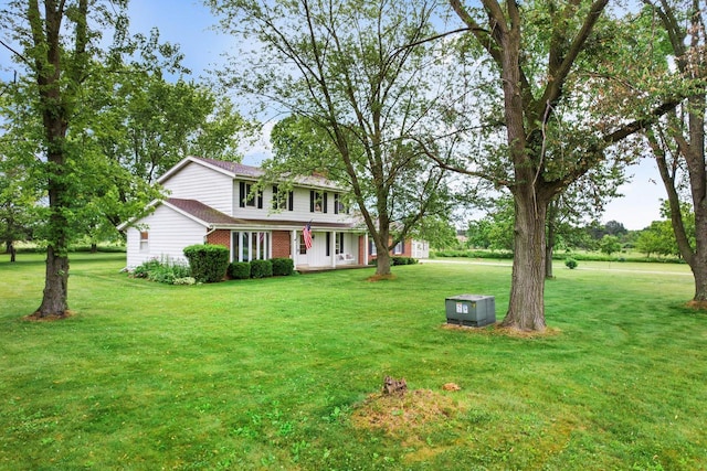 W365N7134 Mcmahon Rd, Oconomowoc, WI 53066 - view of front of home featuring a front lawn and brick siding