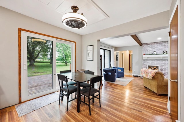 W365N7134 Mcmahon Rd, Oconomowoc, WI 53066 - dining space featuring light wood-style flooring and a brick fireplace