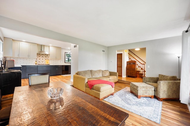 W365N7134 Mcmahon Rd, Oconomowoc, WI 53066 - living area featuring light wood finished floors and stairway
