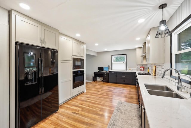 W365N7134 Mcmahon Rd, Oconomowoc, WI 53066 - kitchen featuring black appliances, gray cabinets, light wood-style floors, backsplash, and light stone counters