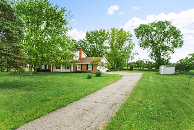 W365N7134 Mcmahon Rd, Oconomowoc, WI 53066 - view of front of home featuring a storage unit, asphalt driveway, a garage, and a front lawn