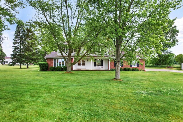 W365N7134 Mcmahon Rd, Oconomowoc, WI 53066 - view of front of home with brick siding and a front lawn