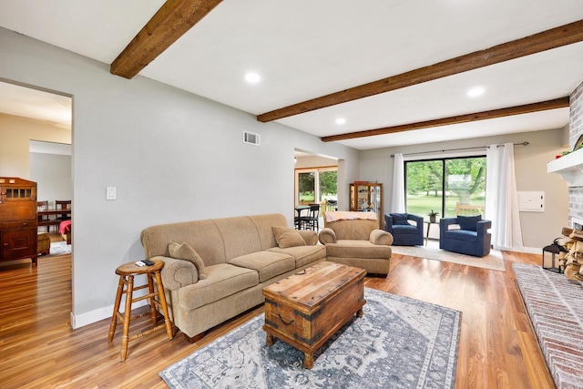 W365N7134 Mcmahon Rd, Oconomowoc, WI 53066 - living area with light wood-style flooring, a fireplace, beam ceiling, and recessed lighting