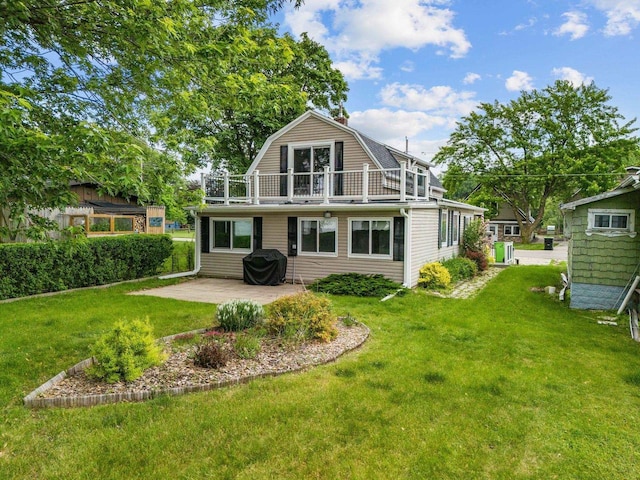 2963 Sunset Point Ln, Oshkosh, WI 54904 - rear view of property with a balcony, a patio area, a gambrel roof, and a lawn