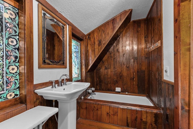 2963 Sunset Point Ln, Oshkosh, WI 54904 - bathroom featuring a garden tub, a textured ceiling, and wood walls