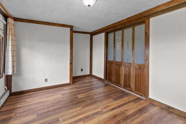 2963 Sunset Point Ln, Oshkosh, WI 54904 - unfurnished bedroom with a textured ceiling and dark wood finished floors