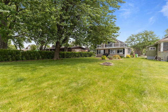 2963 Sunset Point Ln, Oshkosh, WI 54904 - view of green lawn with a balcony and a fire pit