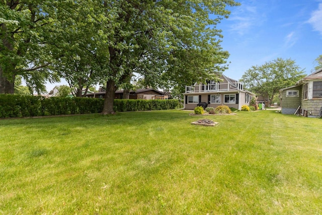 2963 Sunset Point Ln, Oshkosh, WI 54904 - view of grassy yard featuring a fire pit and a balcony