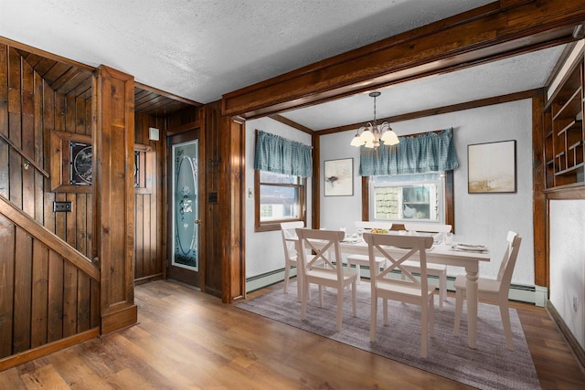2963 Sunset Point Ln, Oshkosh, WI 54904 - dining room featuring wood finished floors, wood walls, a chandelier, a textured ceiling, and stairs