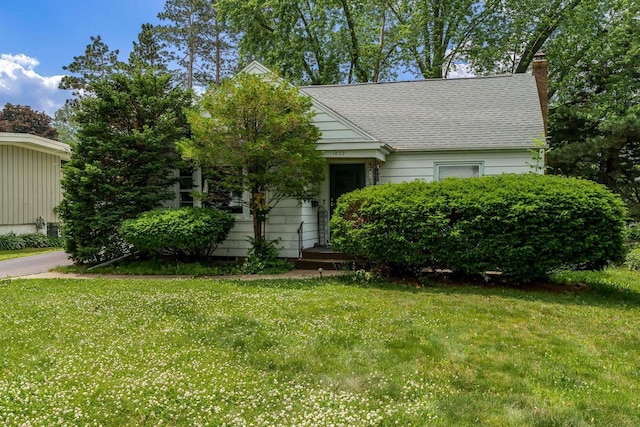 1422 S Burchard Ave, Freeport, IL 61032 - obstructed view of property with a chimney, a front lawn, and roof with shingles