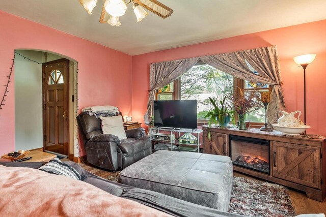 1422 S Burchard Ave, Freeport, IL 61032 - living room with arched walkways, a ceiling fan, and wood finished floors
