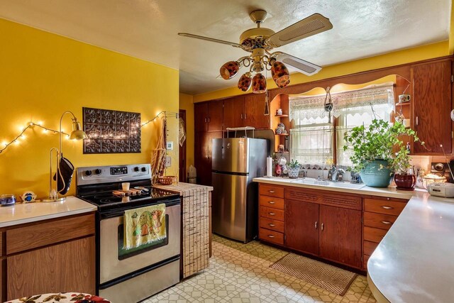 1422 S Burchard Ave, Freeport, IL 61032 - kitchen featuring appliances with stainless steel finishes, open shelves, light countertops, and ceiling fan