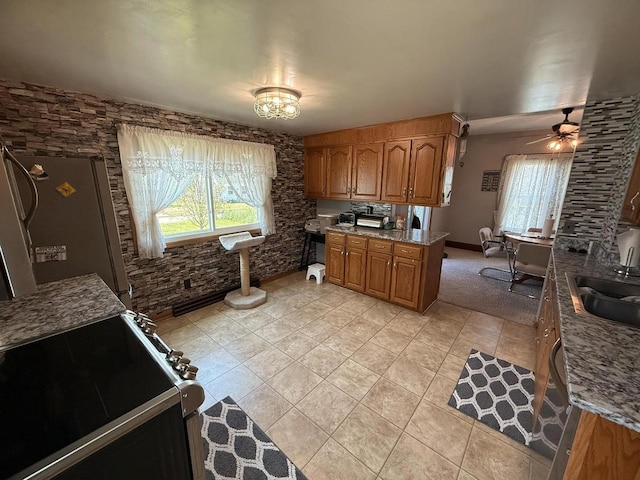 810 10th St, Monroe, WI 53566 - kitchen featuring light tile patterned floors, brown cabinets, range with electric stovetop, ceiling fan, and stone countertops