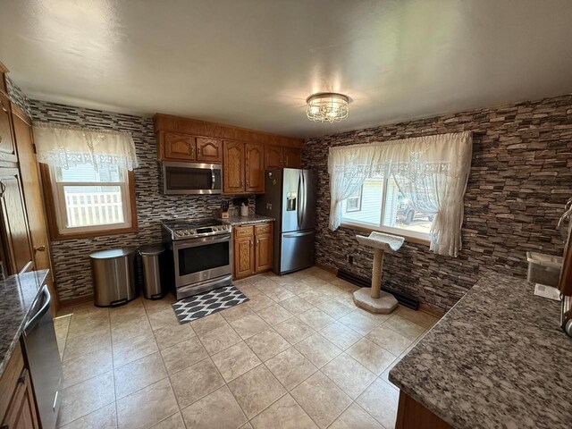 810 10th St, Monroe, WI 53566 - kitchen with stainless steel appliances, brown cabinets, and dark stone counters