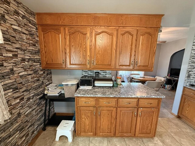 810 10th St, Monroe, WI 53566 - kitchen featuring light stone countertops and brown cabinets