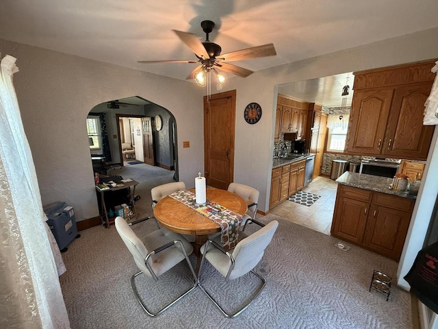810 10th St, Monroe, WI 53566 - dining room with arched walkways, ceiling fan, and light carpet