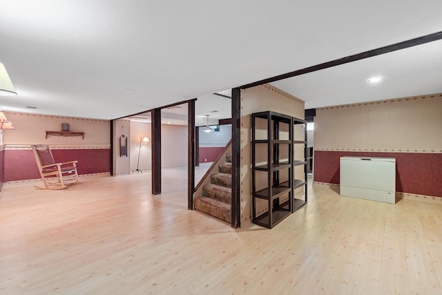 7873 N Edgeworth Dr, Milwaukee, WI 53223 - finished basement featuring wood finished floors, stairway, and wallpapered walls