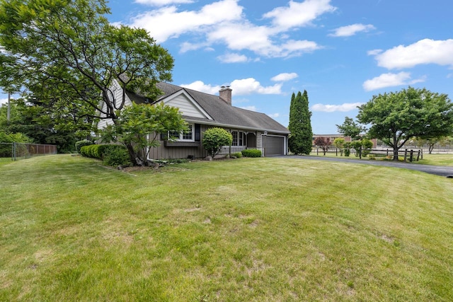 7873 N Edgeworth Dr, Milwaukee, WI 53223 - view of front of home featuring asphalt driveway, a garage, and a chimney