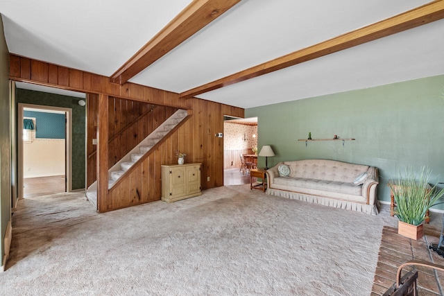 7873 N Edgeworth Dr, Milwaukee, WI 53223 - living area featuring carpet floors, stairs, wood walls, and beam ceiling