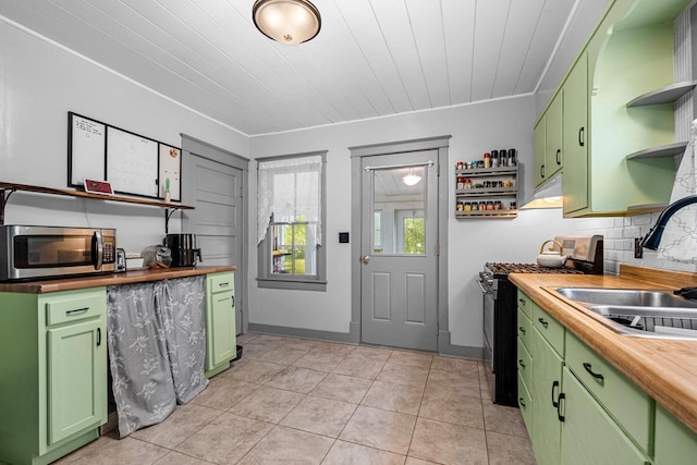 413 S Howard St, Princeton, WI 54968 - kitchen featuring stainless steel appliances, green cabinetry, open shelves, wooden counters, and tasteful backsplash