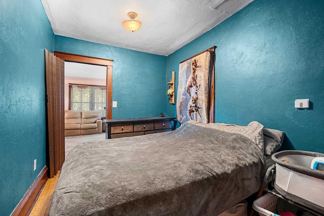 413 S Howard St, Princeton, WI 54968 - bedroom with a textured wall, wood finished floors, and a textured ceiling