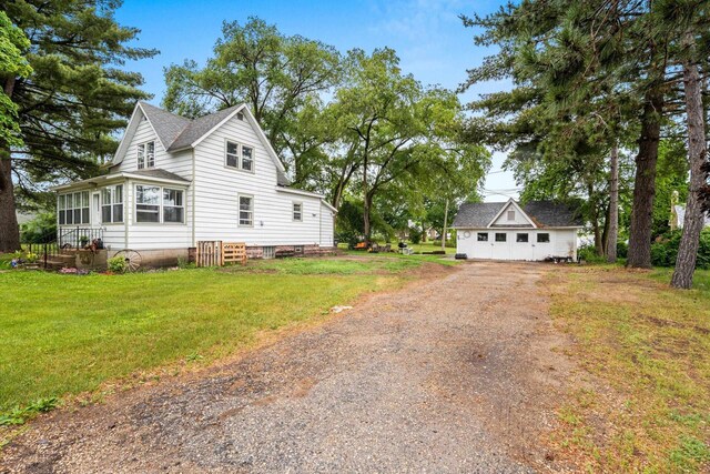 413 S Howard St, Princeton, WI 54968 - view of side of property featuring dirt driveway, a yard, and roof with shingles
