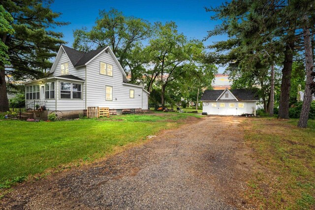 413 S Howard St, Princeton, WI 54968 - property exterior at dusk with driveway and a lawn