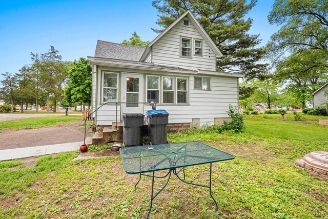 413 S Howard St, Princeton, WI 54968 - rear view of house with a shingled roof and a yard