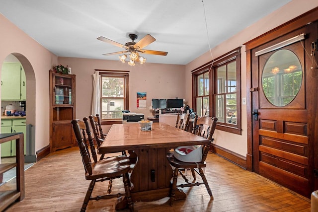 413 S Howard St, Princeton, WI 54968 - dining area with light wood-style floors, arched walkways, and a ceiling fan