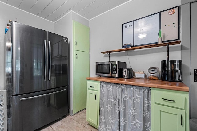 413 S Howard St, Princeton, WI 54968 - kitchen featuring freestanding refrigerator, butcher block countertops, green cabinets, stainless steel microwave, and crown molding