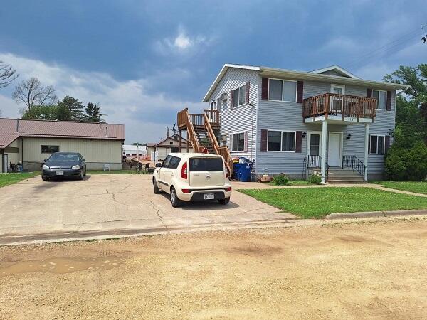 113/115 Oak St, Stoddard, WI 54658 - view of front of home featuring a balcony, a front lawn, and stairs