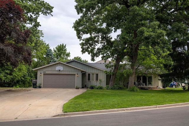133-135 Woodview Dr, Cottage Grove, WI 53527 - single story home with an attached garage, driveway, a front yard, and board and batten siding