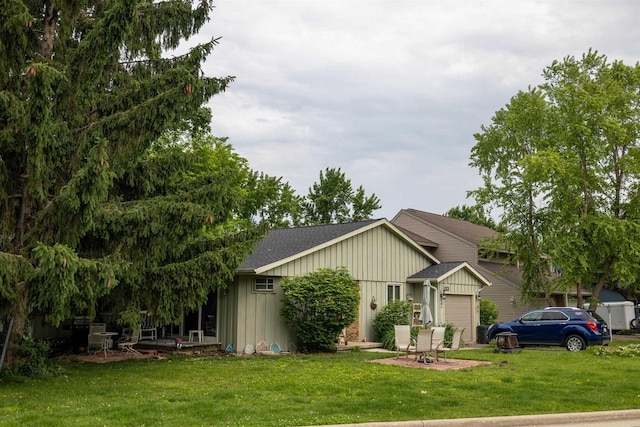 133-135 Woodview Dr, Cottage Grove, WI 53527 - view of front of home with an attached garage, board and batten siding, a front yard, and roof with shingles