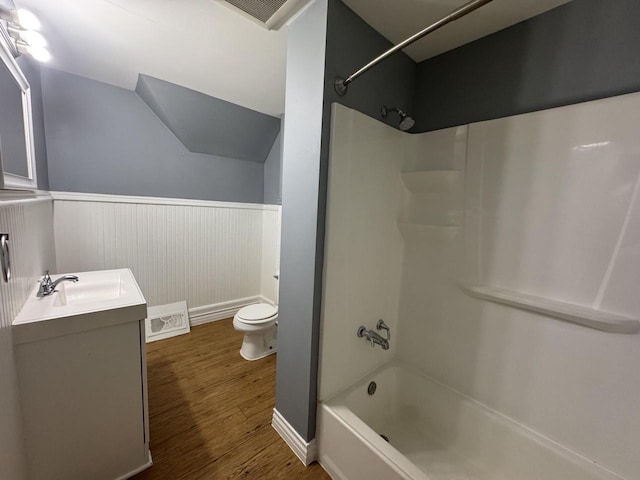 414 Barney St Unit 418, Waukesha, WI 53186 - bathroom with vanity, wainscoting, wood finished floors, shower / bath combination, and vaulted ceiling