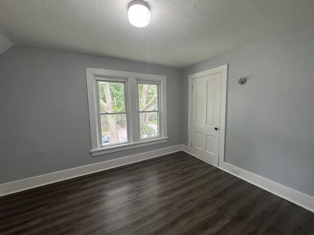 414 Barney St Unit 418, Waukesha, WI 53186 - spare room with baseboards and dark wood-type flooring