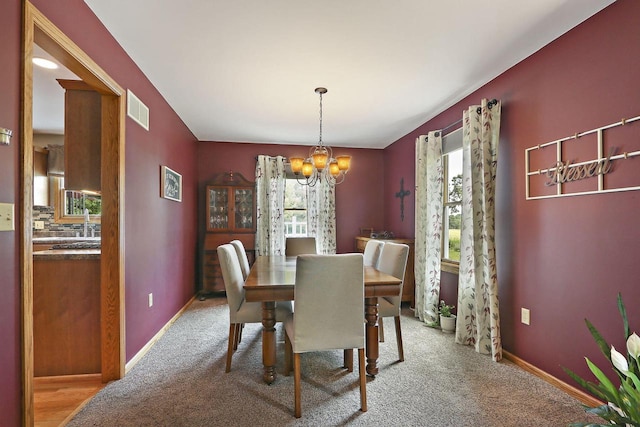 32665 Academy Rd, Burlington, WI 53105 - carpeted dining room with a chandelier and baseboards