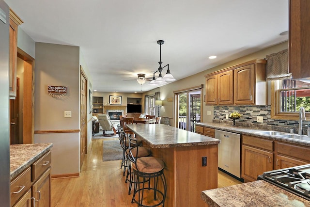 32665 Academy Rd, Burlington, WI 53105 - kitchen featuring ceiling fan, dishwasher, a breakfast bar, backsplash, and a center island