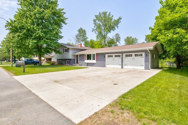 1410 Edwin St, Marinette, WI 54143 - split level home with an attached garage, driveway, and a chimney