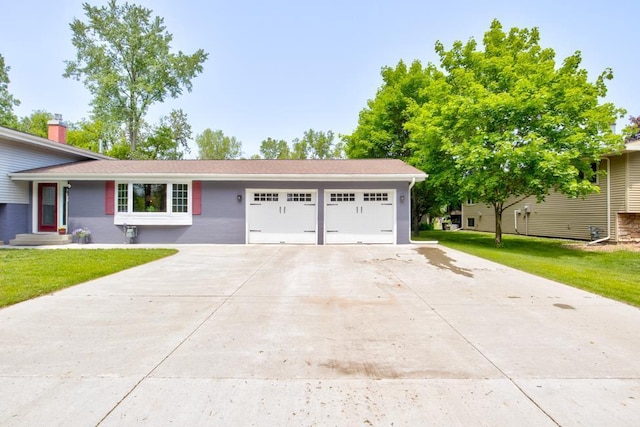 1410 Edwin St, Marinette, WI 54143 - view of front facade featuring a garage, concrete driveway, and a front lawn