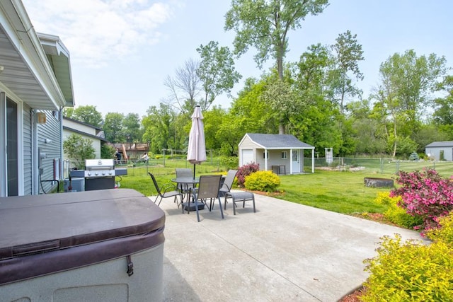1410 Edwin St, Marinette, WI 54143 - fenced backyard with a hot tub, a patio area, outdoor dining area, an outbuilding, and a grill