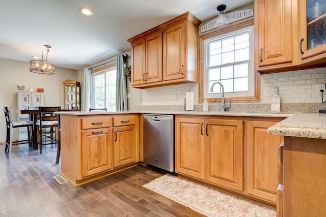 1410 Edwin St, Marinette, WI 54143 - kitchen with dishwasher, a peninsula, dark wood-style floors, light stone counters, and tasteful backsplash