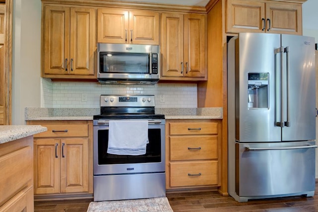 1410 Edwin St, Marinette, WI 54143 - kitchen featuring stainless steel appliances, dark wood-type flooring, light stone countertops, and decorative backsplash