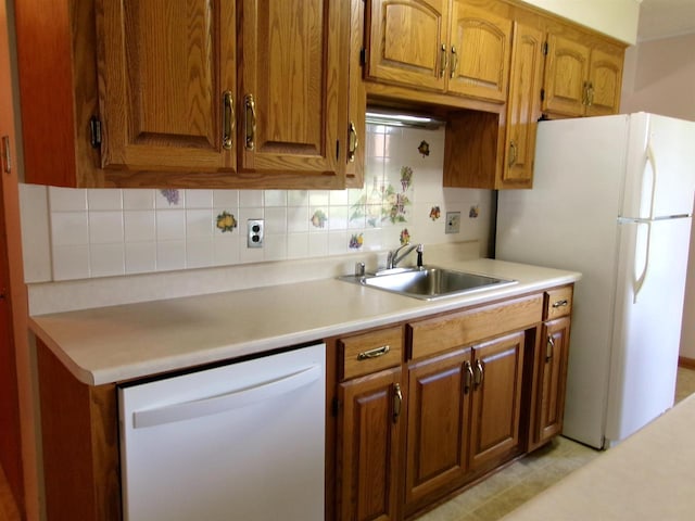 116 Mohawk Dr, Beaver Dam, WI 53916 - kitchen featuring white appliances, brown cabinets, light countertops, and tasteful backsplash
