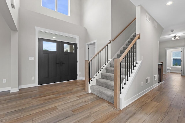 N65W34963 Baltic Pass, Oconomowoc, WI 53066 - entryway featuring wood finished floors, stairs, a high ceiling, and recessed lighting