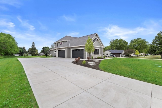 N65W34963 Baltic Pass, Oconomowoc, WI 53066 - view of front of home with driveway, a front lawn, stone siding, board and batten siding, and an attached garage