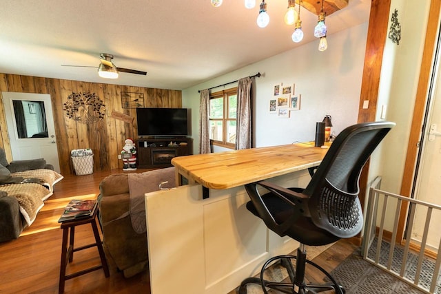 1116 Lagrange Ave, Tomah, WI 54660 - living room featuring wood finished floors, wood walls, and a ceiling fan