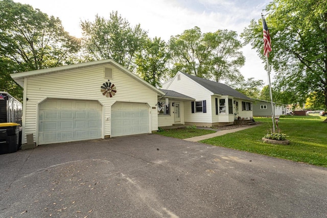 1116 Lagrange Ave, Tomah, WI 54660 - ranch-style house featuring asphalt driveway, an attached garage, and a front yard